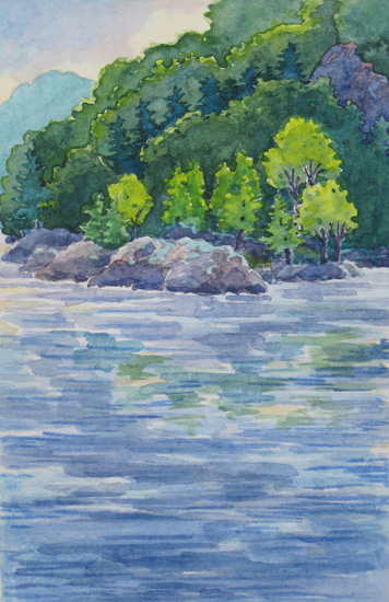 An island of rock against the green hills.